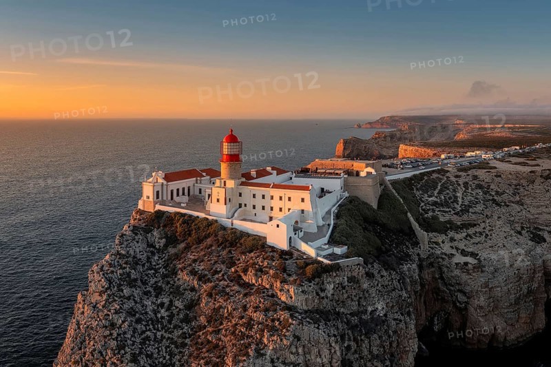 Portuguese coast with a lighthouse in the rays of the setting sun, Cabo De Sao Vincente on sunset