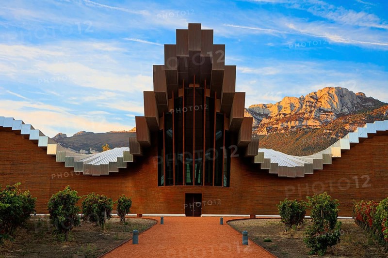 Fantastic beauty. The magnificent modern architecture of Bodegas Ysios. Bright flaming colors of the sunset. Journey to the warm Spanish autumn