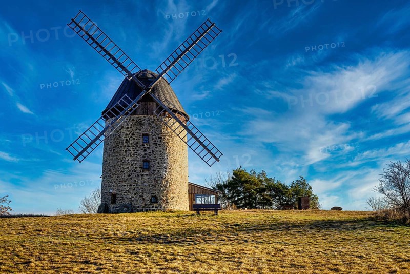 A windmill in the field in the daytime