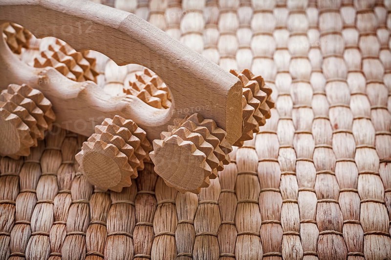 Close up image of wooden relaxing massager on wicker background healthcare concept