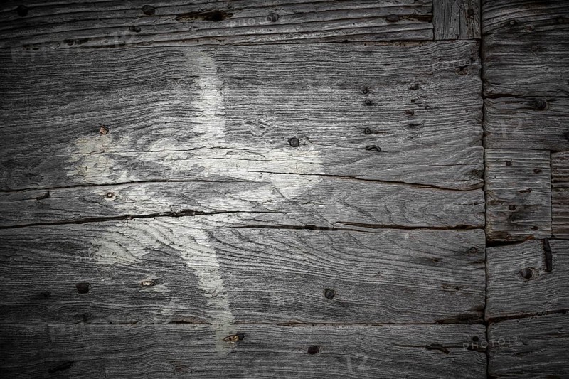 White star painted on the old cracked wood with worn-out paint. Grunge look