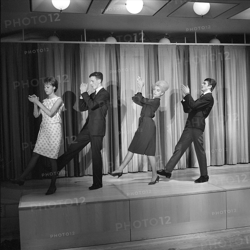 Dancing in the 1960s. The dance Hully Gully is being made popular and here are men and women dancing the new craze. Hully Gully was a type of unstructured line dance and consisted of a series of steps and was relatively simple and easy to execute. Hully Gully can be seen performed by actor John Belushi in the film Blues Brothers. Picture taken 1963