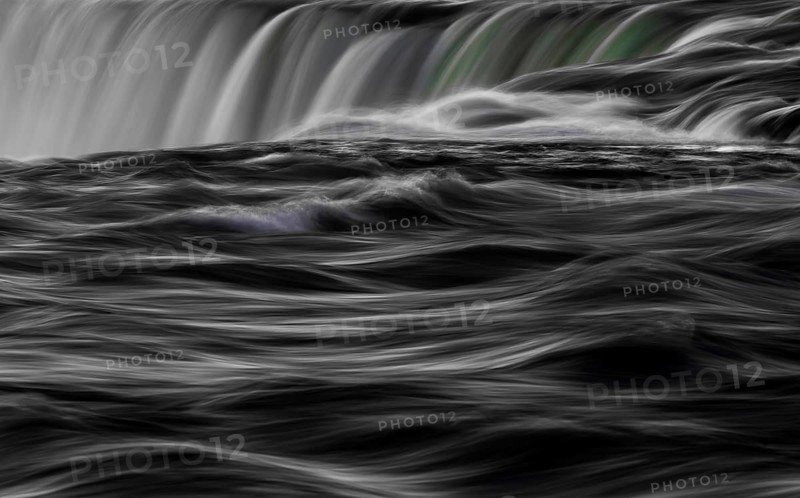 Abstract image of a dynamic, Horseshoe Falls of Niagara Falls in black and white with swirling water as seen from Niagara Falls, Ontario, Canada, North America