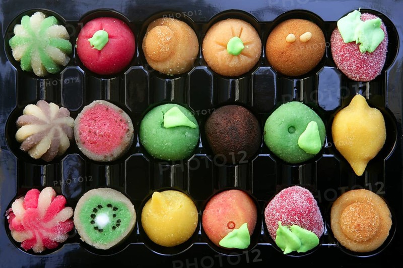 Colorful marzipan sweets with fruits shapes made of almond and sugar