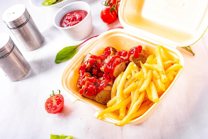 Grilled bratwurst with French fries and ketchup
