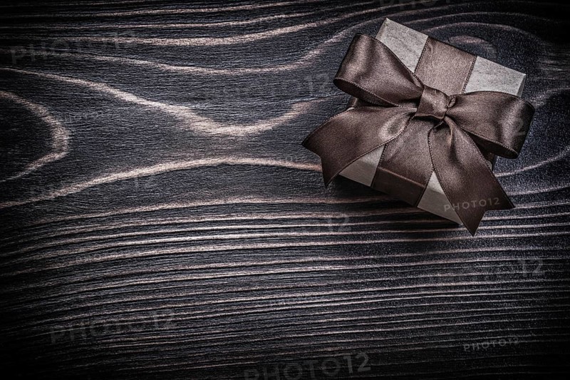 Present box on wooden board holidays concept