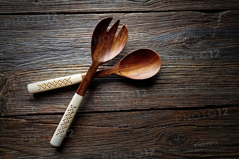 Wooden kitchen tools spatules spoon and fork kitchenware on wooden background
