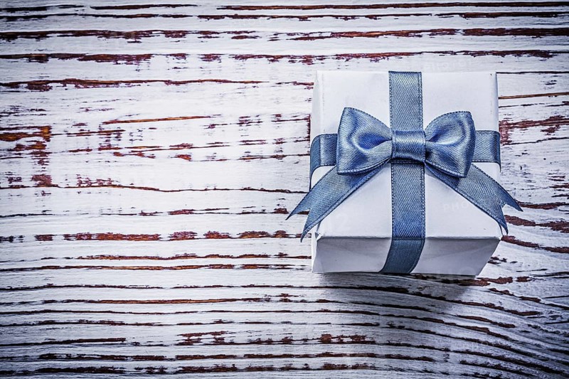 Present box on vintage wooden board holidays concept