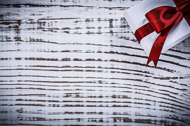 Present box on vintage wooden board copyspace holidays concept