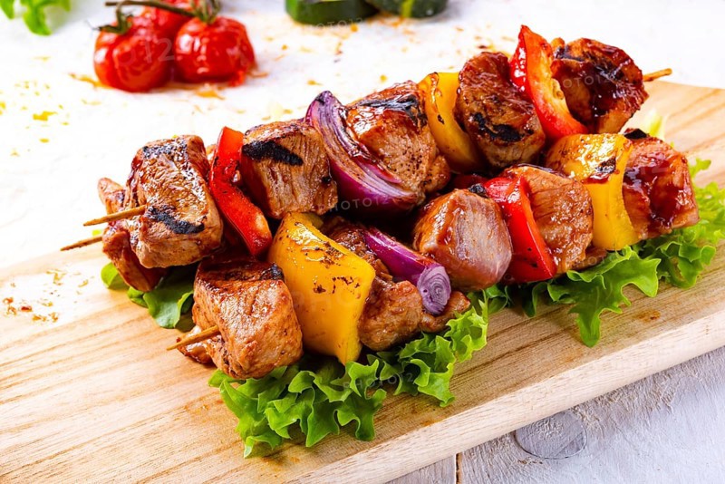 Tasty and colorful meat skewers with peppers and onions
