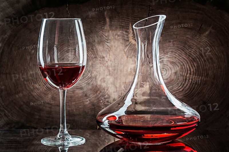 Wineglasss And Decanter With Red Wine On Vintage Wood Background