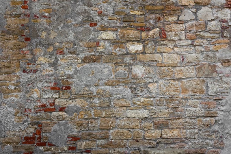 Rustic wall made of clay bricks brown and red