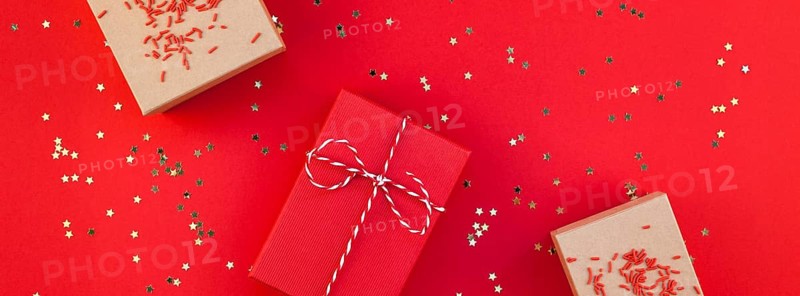 New Year or Christmas presents wrapped ribbon flat lay top view Xmas holiday 2019 celebration handmade gift boxes red paper golden sparkles background. Template mockup greeting card long wide banner