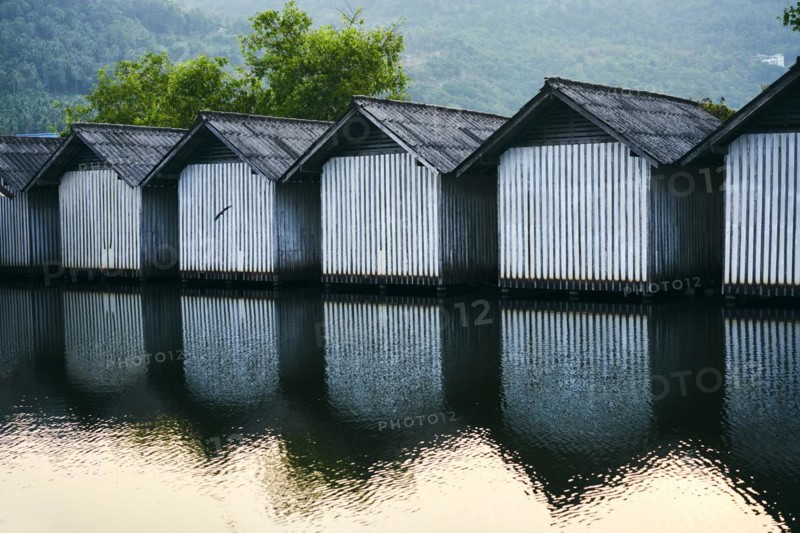 Row of houses on the river with reflections in the water