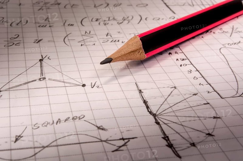 Pencil on notebook, full of mathematical formulas