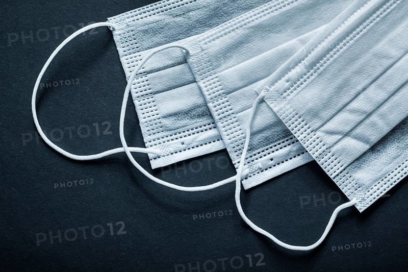 Disposable sterile face masks on black background