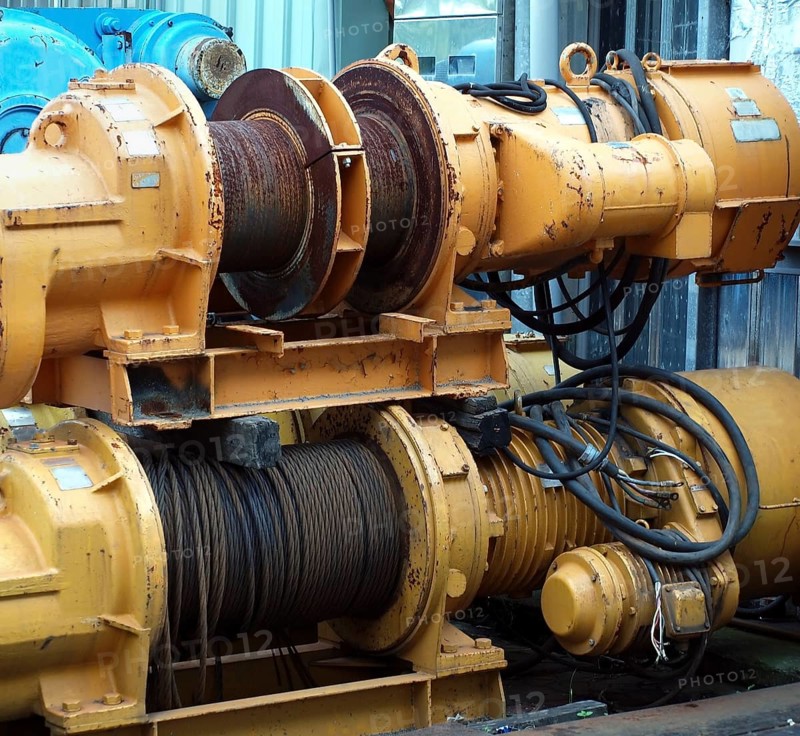 Large industrial winches are used to haul in steel cables
