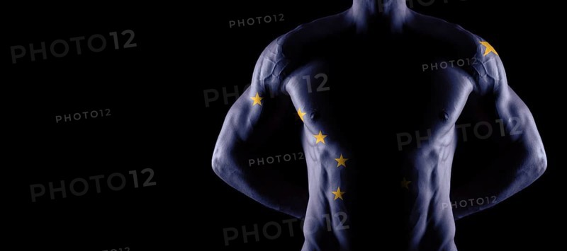 Alaska flag on muscled male torso with abs, Alaska bodybuilding concept, black background