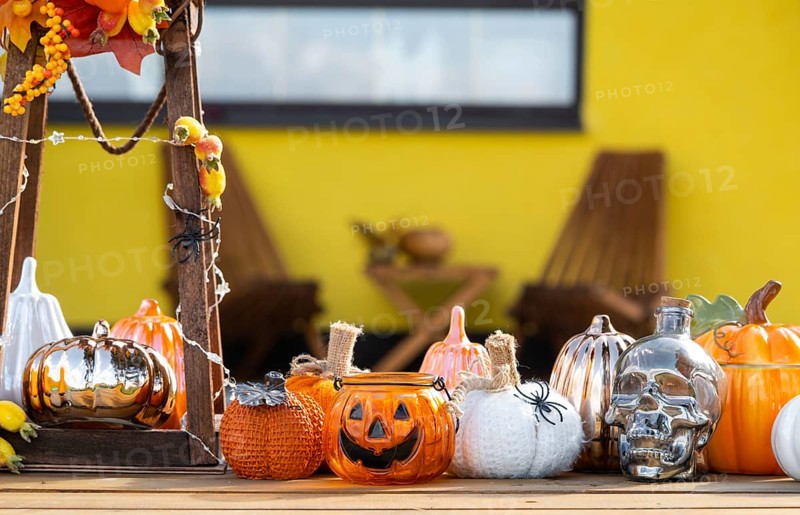 Autumn decor on the porch of the house outside in the yard of pumpkin, lantern, garlands, hats, jack lantern. Halloween party, autumn mood, Harvest festival