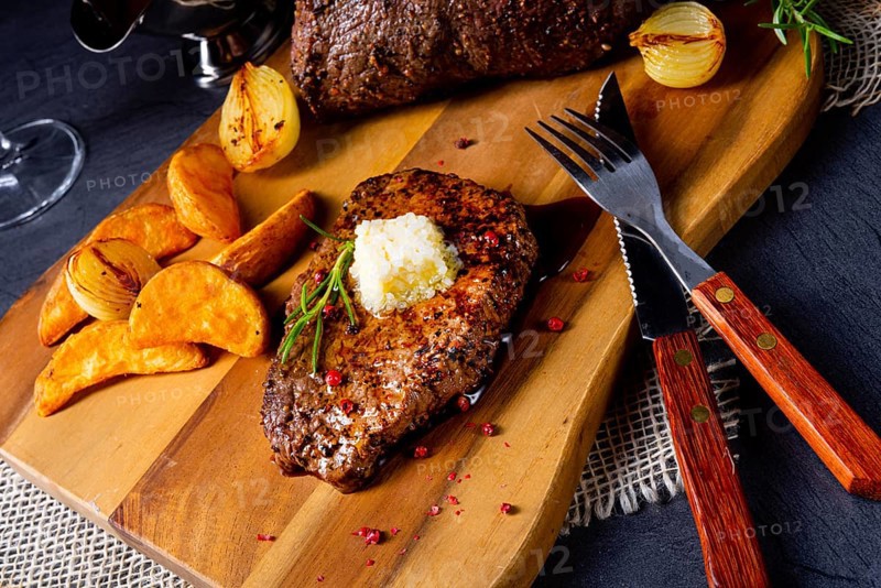 Butter beef steak with herbs and potato wedges