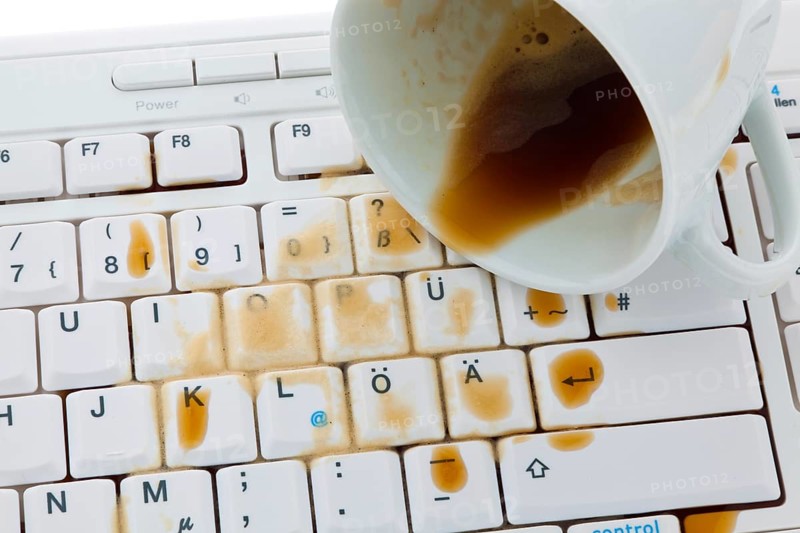 Cup of coffee spilled on a computer keyboard. Damage for insurance, Cup of coffee spilled on a computer keyboard. Damage insurance. Austria