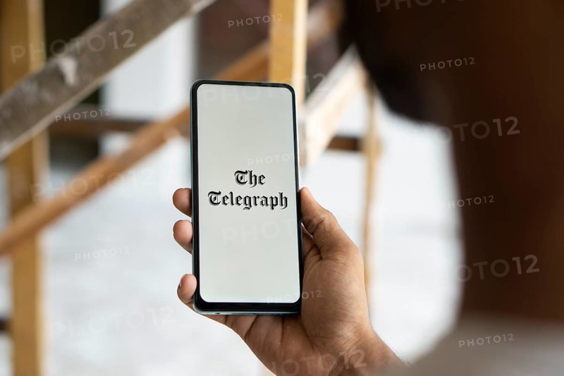 the telegraph logo is displayed on smartphone. The Telegraph is a British daily broadsheet newspaper published company