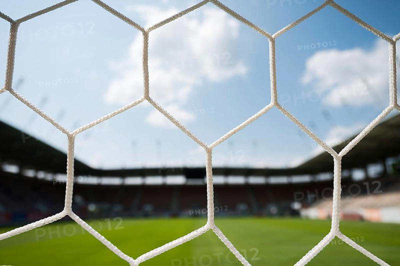 Net on a soccer goal and stadium in the background in Lubin, Poland