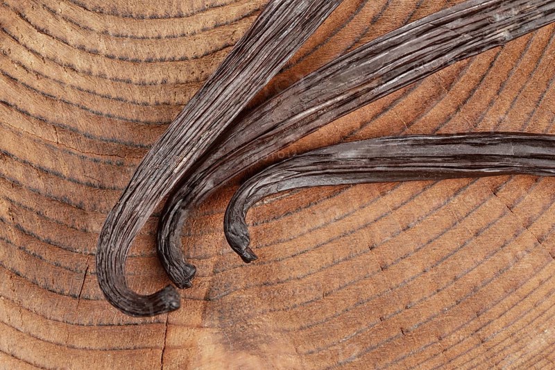 Vanilla beans on wooden board, closeup photo from above, Pribylina, Slovakia