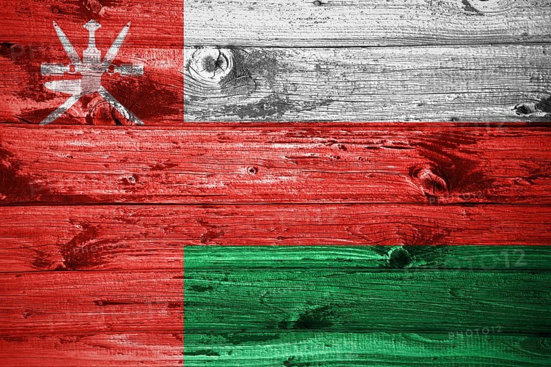 Oman flag on wooden planks background wood flag