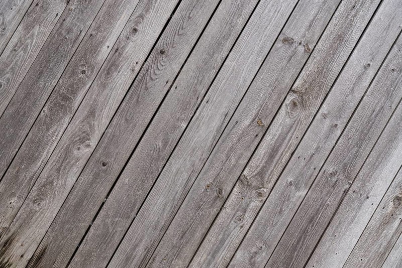 Crooked weathered old wooden wall - text space, close-up