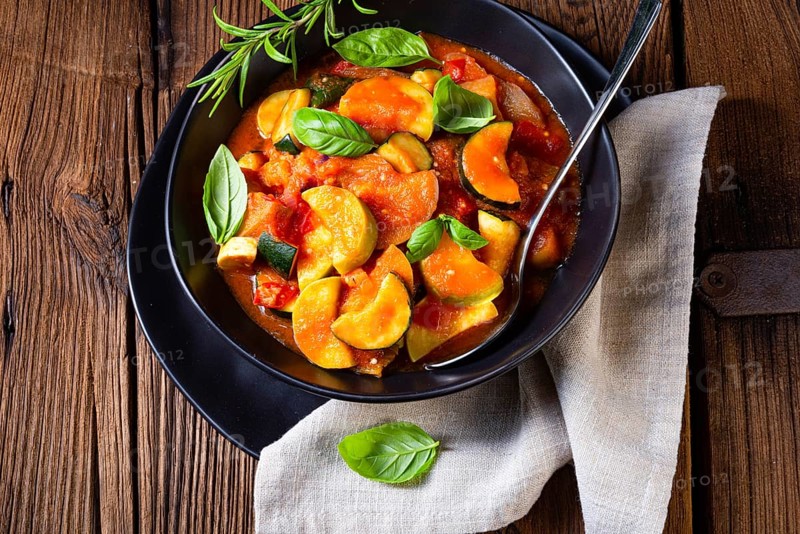 Vegetarian courgette ratatouille with tomato sauce and herbs