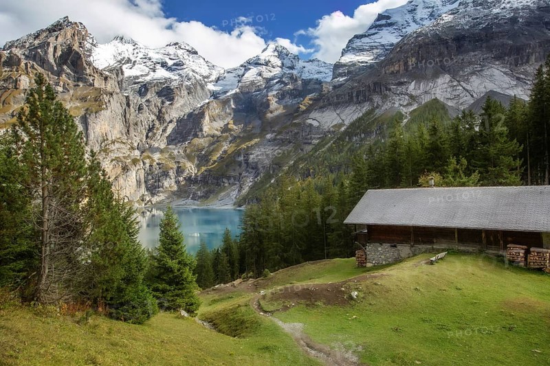 Amazing tourquise Oeschinnensee lake, wooden chalet and Swiss Alps, Berner Oberland, Switzerland