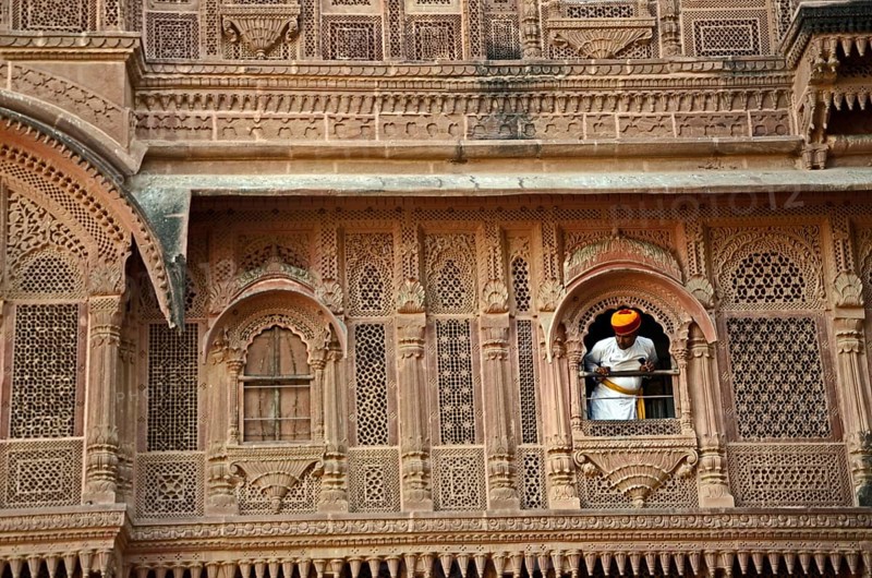 Man peeping out of palace window at Mehrangarh Fort, Jodhpur, Rajasthan, India, Asia