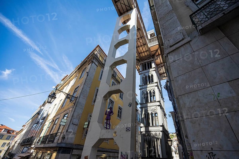 An urban area with historic buildings and an iconic lift under a blue sky in Lisbon, Elevador de Santa Justa in Lisbon, Portugal