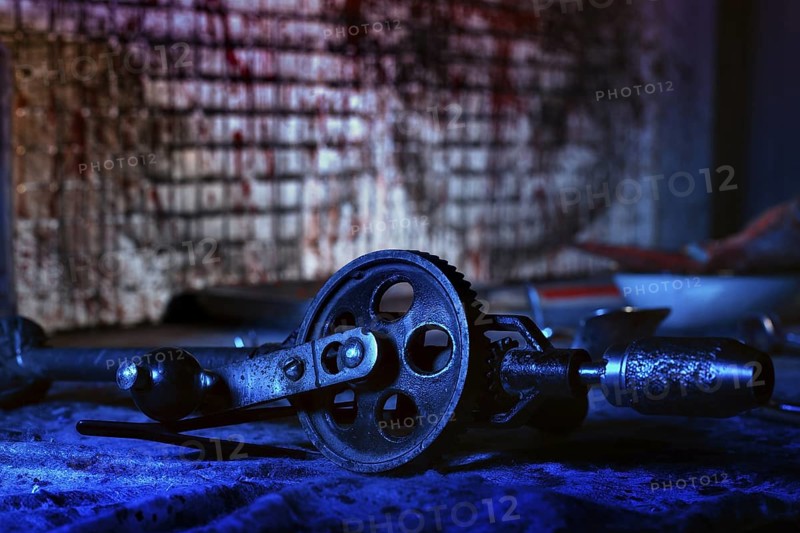 A creepy room with bloodstained walls and medical instruments. The basement of a homicidal maniac with the remains of the victim. Close up