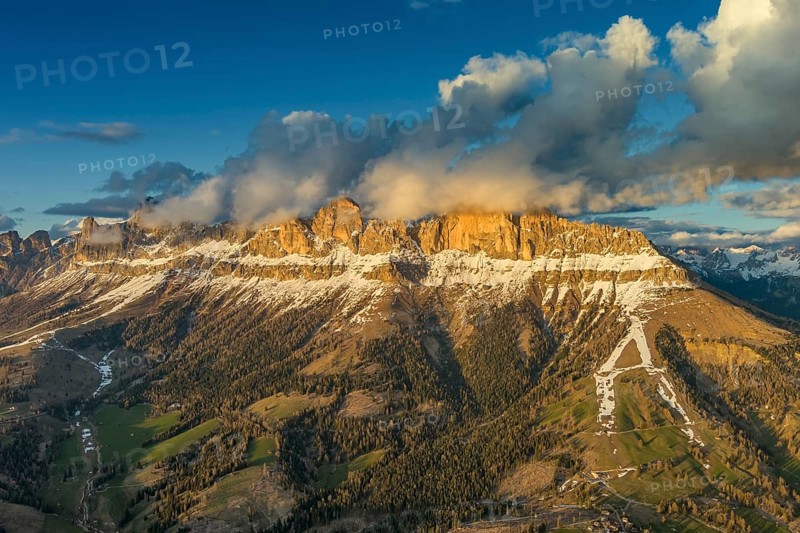 Aerial view of amazing rocky mountains in snow at sunset, Dolomites, Italy