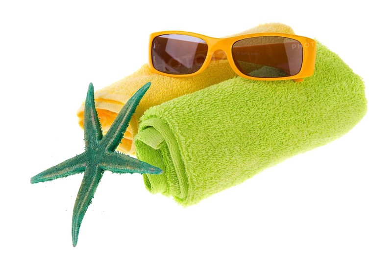 Green towel, starfish and sunglasses for the beach