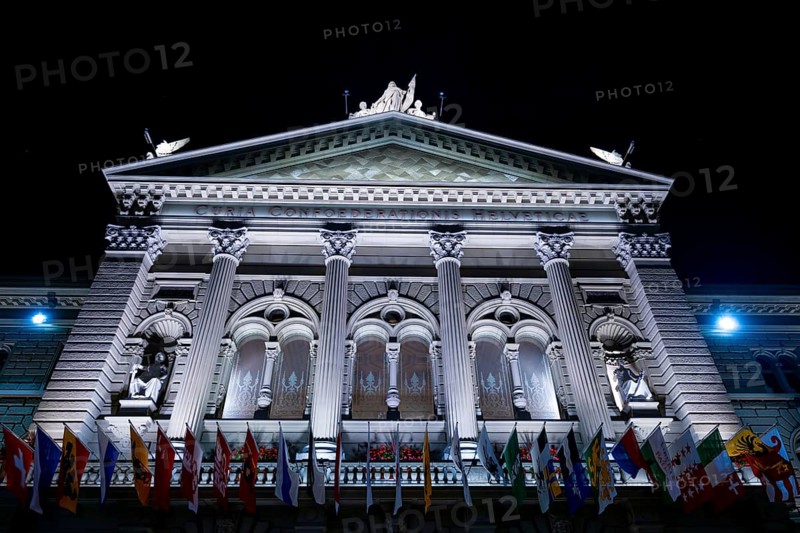 Beautiful Bundeshaus Illuminated Parliament Building or Federal Palace with Canton Flags at Night in City of Bern, Bern Canton, Switzerland