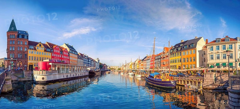 Panorama of the Nyhavn canal with boats, ships and many small colorful houses. Copenhagen, Denmark