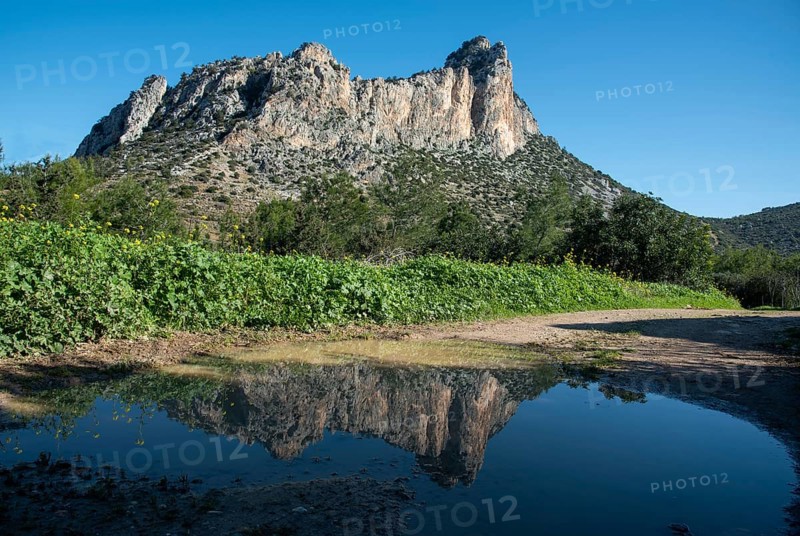 Famous Pentadaktylos rocky mountain peaks reflected on water in Kerynia town in Cyprus late in the evening. It is named as five finger mountain because of the five peaks