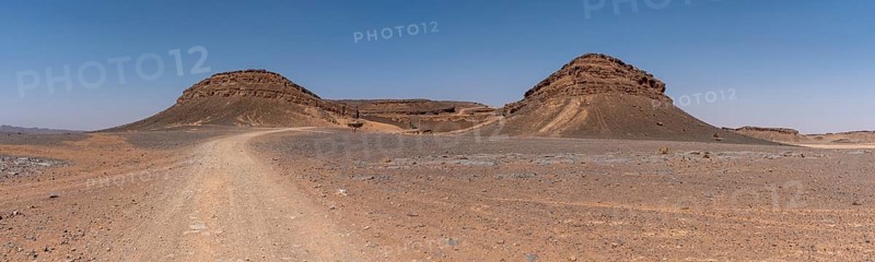 Iconic horseshoe mountain Gara Medouar in the desert near Merzouga, known for different film sets, Morocco