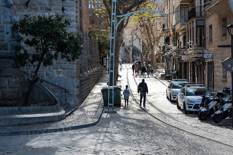 Soller, Spain, 12 25 2017: main street with a few people and cars parked