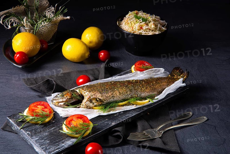 Baked trout with herb filling and tomatoes