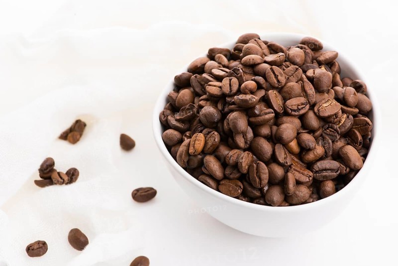 Bowl of caffee beans on a white background