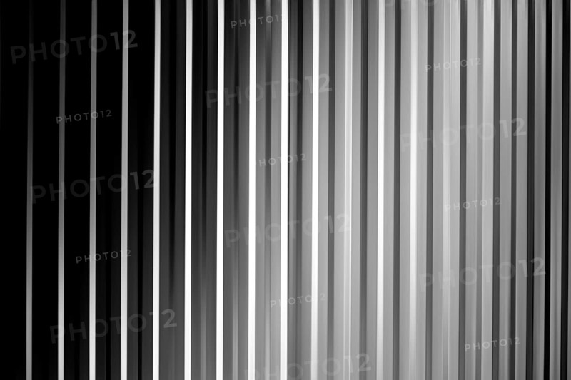 An abstract black, white and grey striped surface with shadows and vignettes