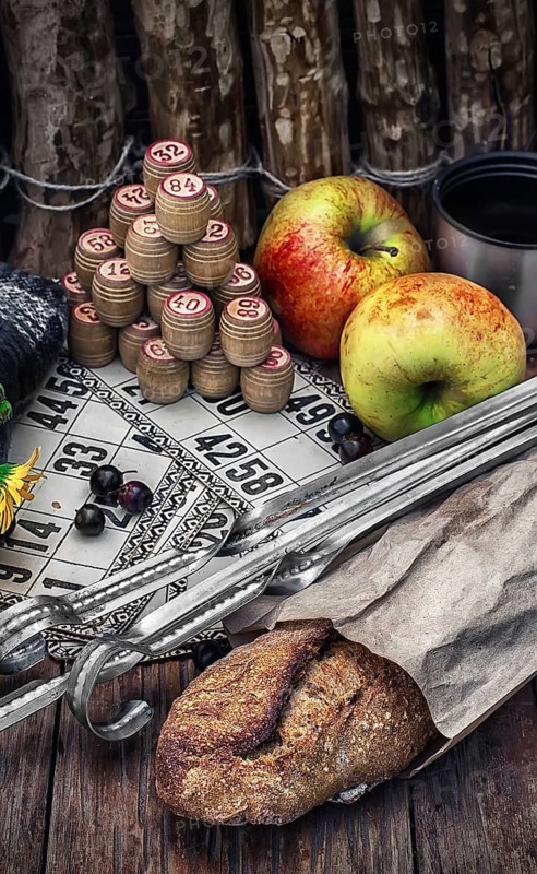 Accessories picnic consisting of peaches, apples and lotto games.Photo tinted