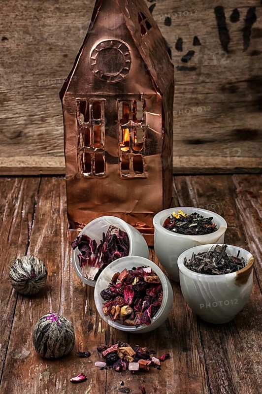 Tea leaves on the background of the house foil on wooden surface.photo tinted