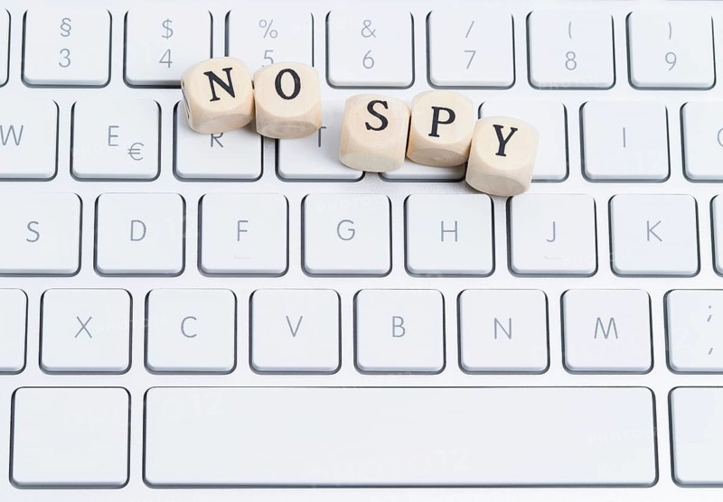 The photo shows a keyboard with wooden letters with the words
