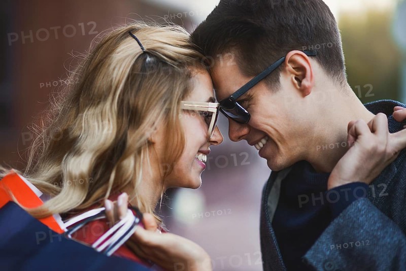 Picture showing young couple shopping in the city. Portrait of a couple with shopping bags in the city.People, sale, love and happiness concept