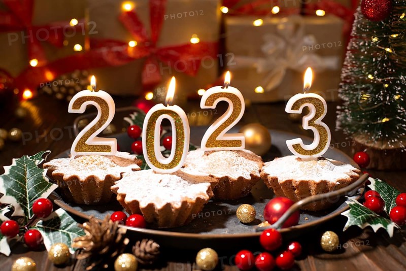 Food tray with cupcakes new year candles and christmas decorations